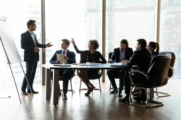 Confident female employee interact with coach at presentation