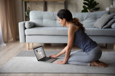 Bilgisayarda ücretsiz yoga kursunu seçen motive olmuş genç bir kadın..