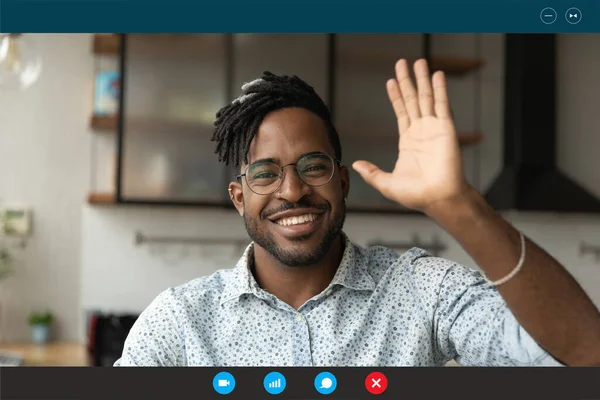 Young african ethnicity handsome bearded man making hello gesture.