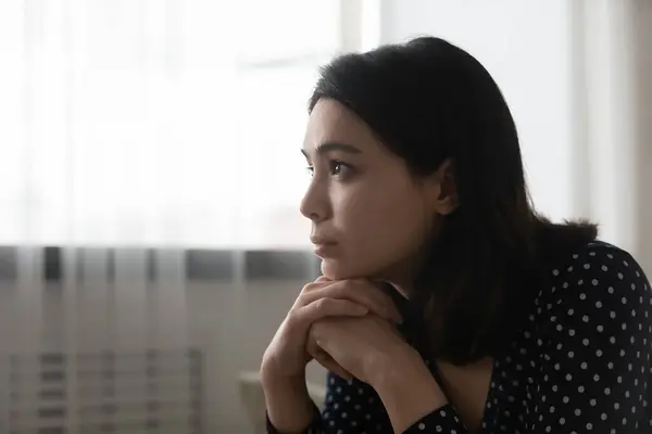 Close up thoughtful upset Asian woman thinking about personal problems — Stock Photo, Image