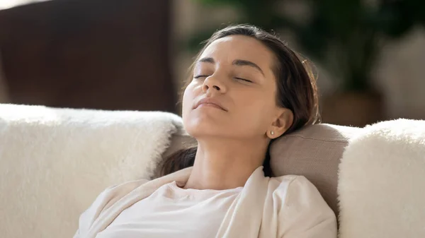 Tired young lady resting on couch napping after work day — Stock Photo, Image