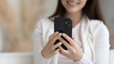 Modern akıllı telefonu tutan gülümseyen kadın görüntüsünü kapat.