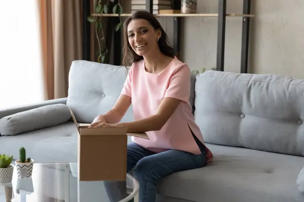 Happy young indian arabian ethnicity woman unboxing carton parcel. — Stock Photo, Image