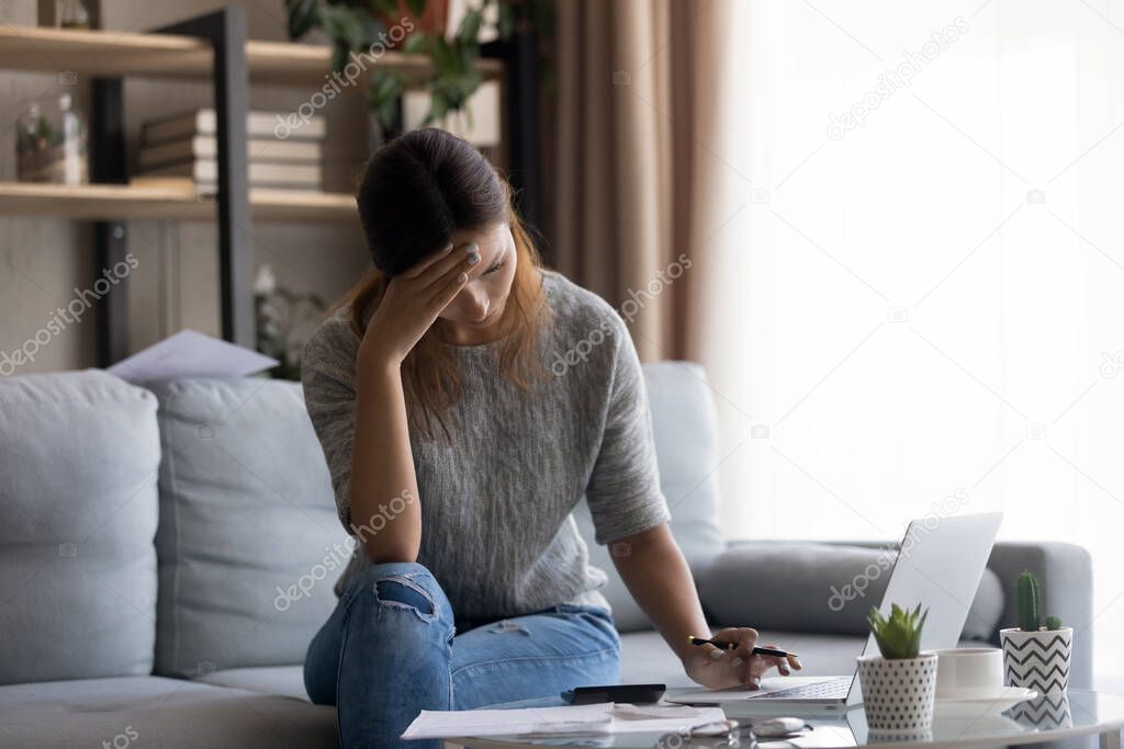 Unhappy young caucasian woman feeling stressed about lack of money.