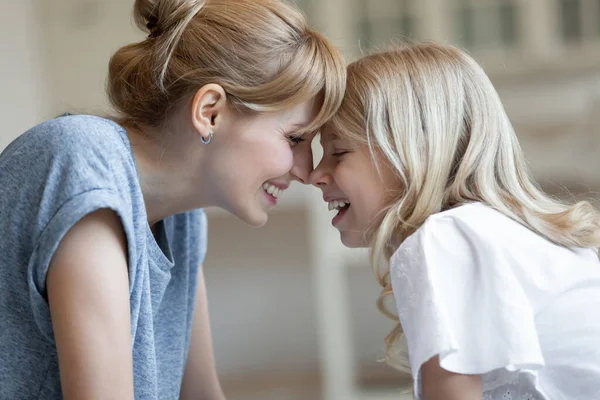 Close up happy laughing mother and little daughter touching foreheads — Stock Photo, Image