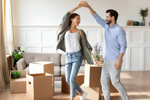 Happy couple renters dance on moving day