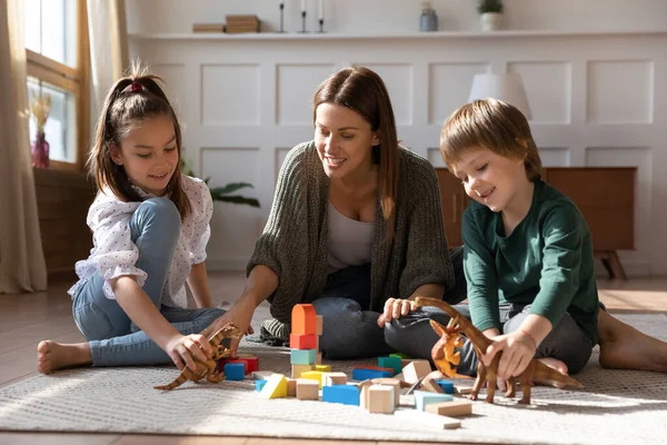 Caring single mother play with two children at home — Stock Photo, Image