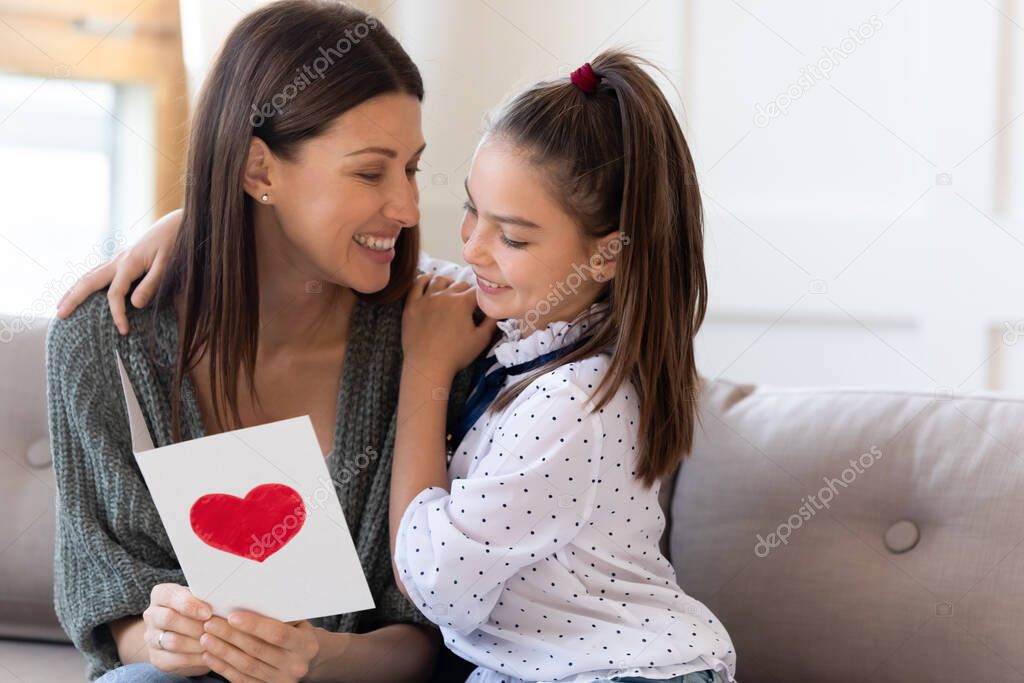 Caring daughter greeting excited mom with birthday