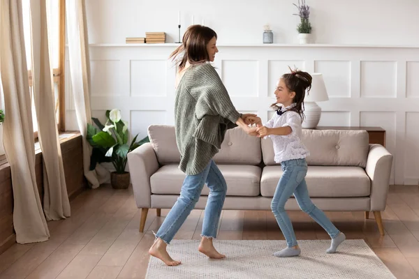 Šťastná maminka a malá dcera tančí o víkendu doma — Stock fotografie