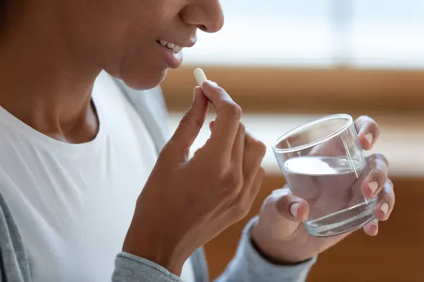 Close up of woman take vitamins or medicines — Stock Photo, Image