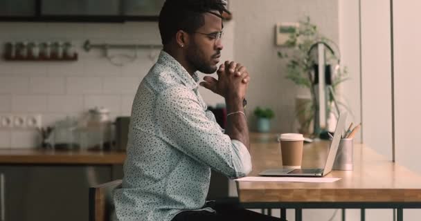 African man drink coffee keep business correspondence using computer — Stock video