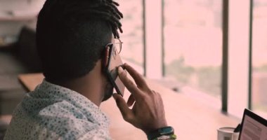 Close up side view african businessman talking on phone