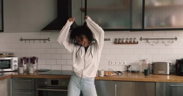 Carefree african woman dancing in kitchen at home — Video