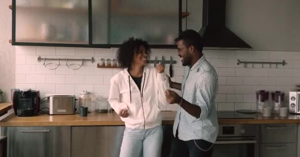 Lively happy african couple dancing in modern kitchen — Wideo stockowe