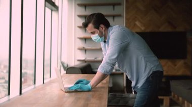 Employees in face masks greeting each other making elbow bump