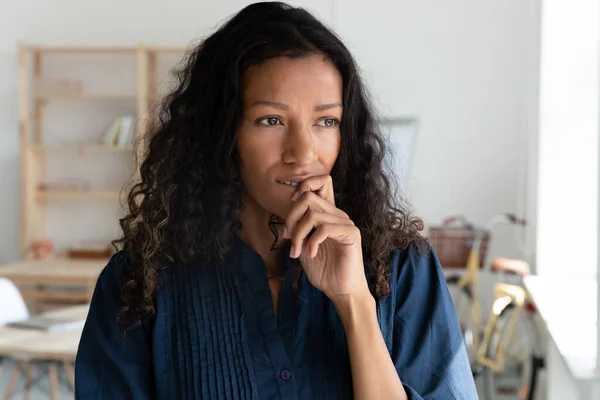 Pensive biracial female employee look in distance — Stockfoto