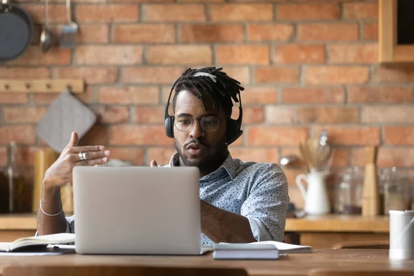 Serious young african ethnicity man holding video call conversation. — Stock Photo, Image