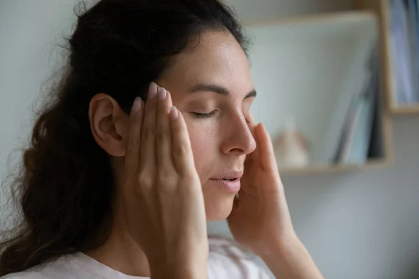 Close up upset woman touching temples, suffering from headache — Stock Photo, Image