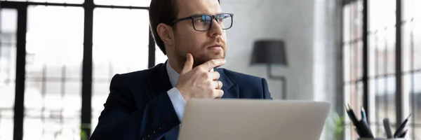 Close up thoughtful motivated businessman wearing glasses looking to aside — Stock Photo, Image
