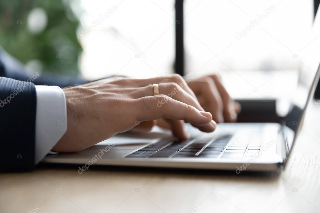 Close up businessman using laptop, typing, writing email or report