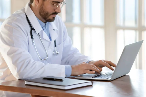 Male doctor work on computer in modern clinic