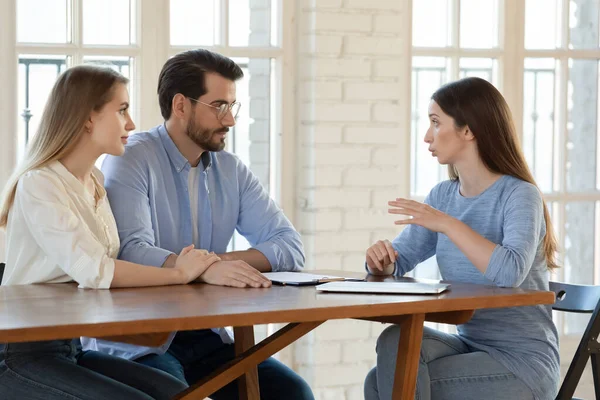 Kvinnlig mäklare konsultera par om hem köp — Stockfoto