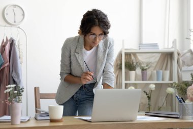 İlgilenen bayan tasarımcı bilgisayar ekranında duruyor ve yeni bir taslak oluşturuyor