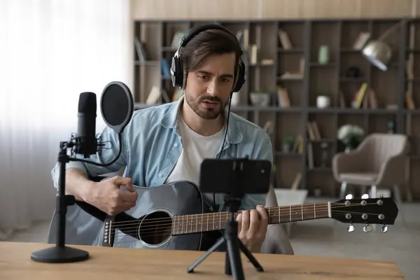 Young male artist record guitar lesson on cellphone — Stock Photo, Image