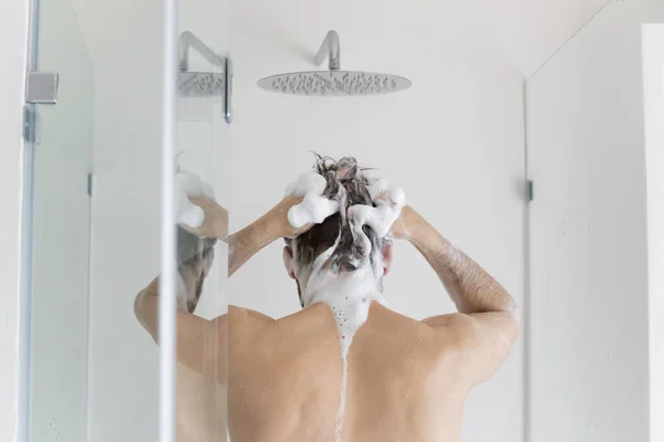 Rear back view young caucasian man taking shower. — Stock Photo, Image