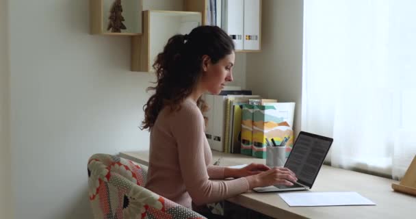 Geconcentreerde jonge Kaukasische zakenvrouw werken met documenten op de computer. — Stockvideo