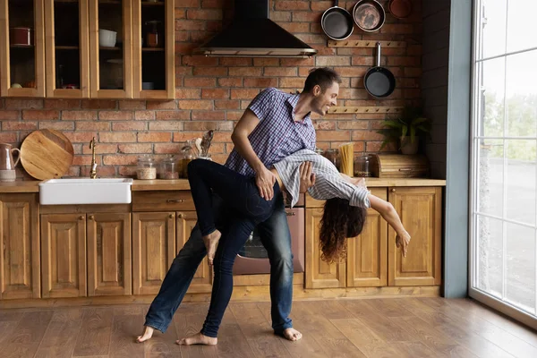 Pareja joven teniendo cita en interiores bailando apasionada discoteca en la cocina — Foto de Stock