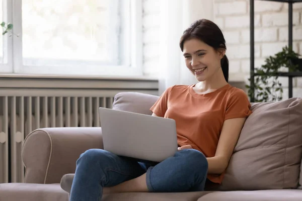 Young woman spending time indoors at quarantine period communicating online — Stock Photo, Image