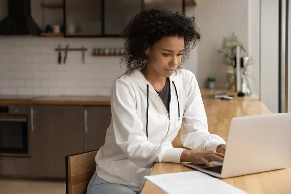 Афроамериканка работает онлайн на ноутбуке — стоковое фото