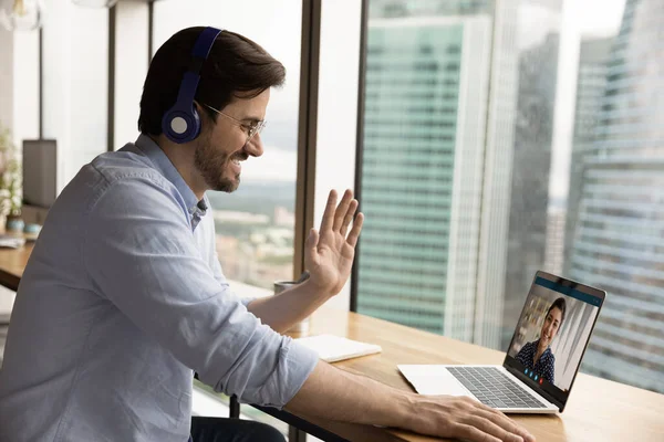 Smiling Caucasian man talk on video call on laptop — Stock Photo, Image