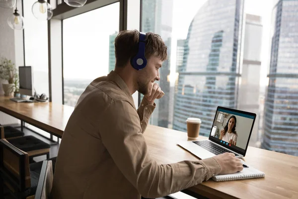 Smiling man in headphones study distant with coach on computer — Stock Photo, Image