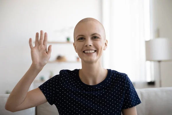 Laughing woman oncology patient calling home by video waving hand — Stock Photo, Image