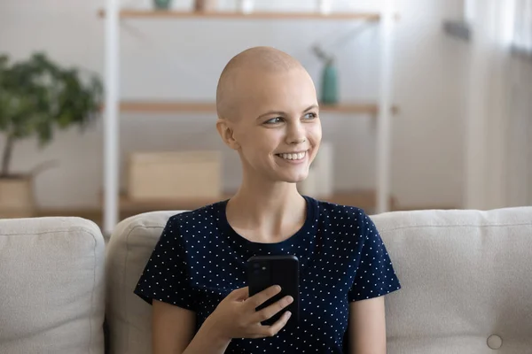 Positive woman having oncology relax at home using cell — Stock Photo, Image