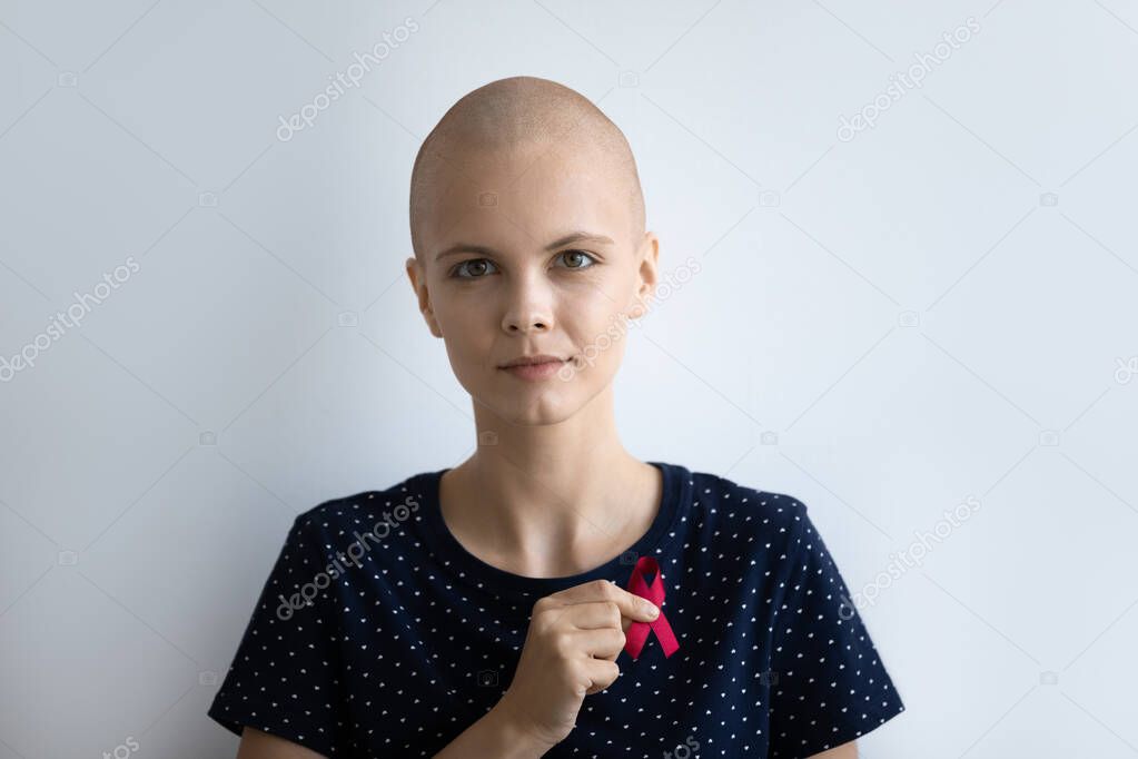 Hairless lady oncology disease victim hold red ribbon at chest