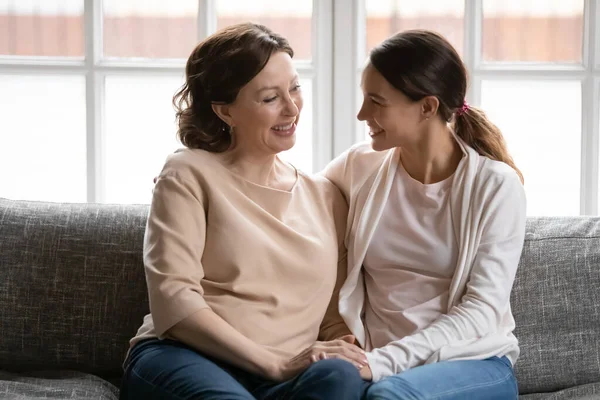 Glückliche Mutter mittleren Alters und erwachsene Tochter halten Händchen — Stockfoto