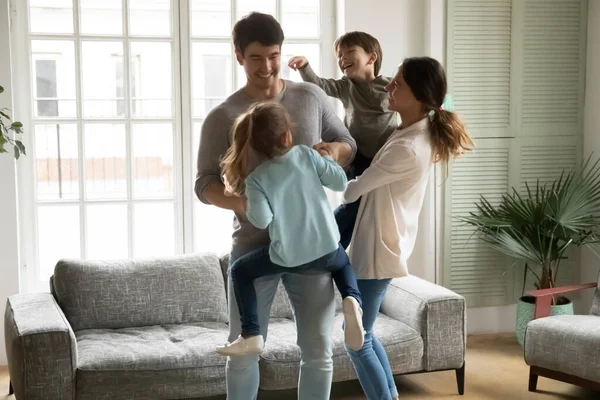 Overjoyed family with kids having fun, dancing, moving to music — Stock Photo, Image