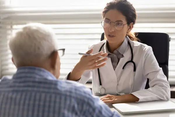 Female doctor have consultation with elderly patient — Stock Photo, Image