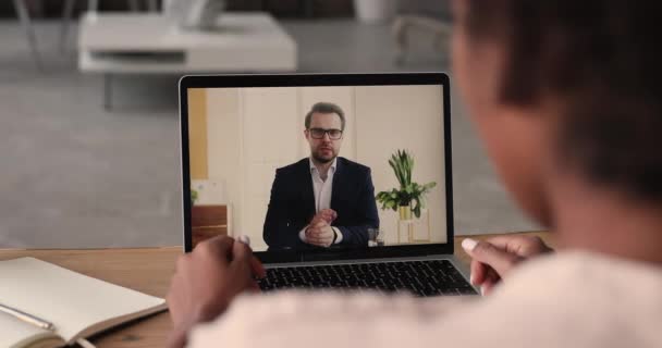 African businesswoman talk to male colleague using videoconference on laptop — Stock Video