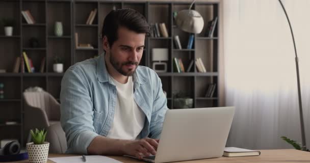 Man lees e-mail op laptop voelt zich gelukkig door goed nieuws — Stockvideo