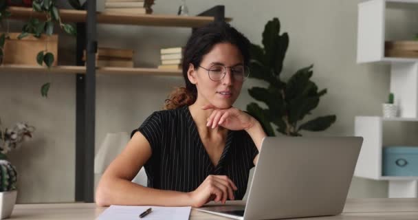 Atractiva dama de negocios sentada en el escritorio mensajes de texto en el ordenador portátil — Vídeos de Stock