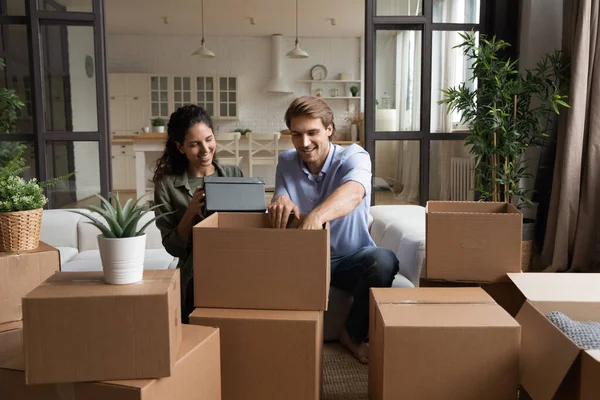 Emocionada pareja desempacando cajas moviéndose juntos —  Fotos de Stock