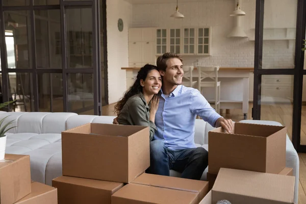 Happy couple relax on moving day dreaming — Stock Photo, Image