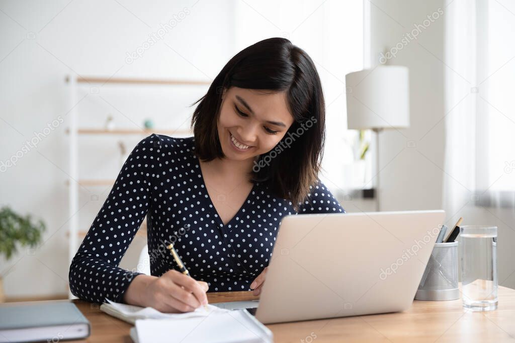 Happy young smart korean vietnamese woman enjoying studying online.