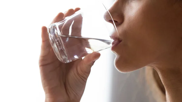 Close up woman holding glass, drinking still mineral water — Stock Photo, Image