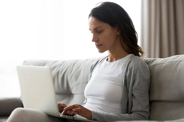 Close up woman using laptop, working online, sitting on couch — Stock Photo, Image