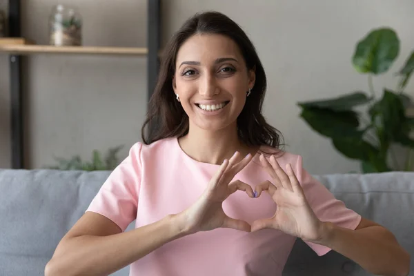 Porträt einer glücklichen ethnischen Frau zeigt Liebesgeste — Stockfoto